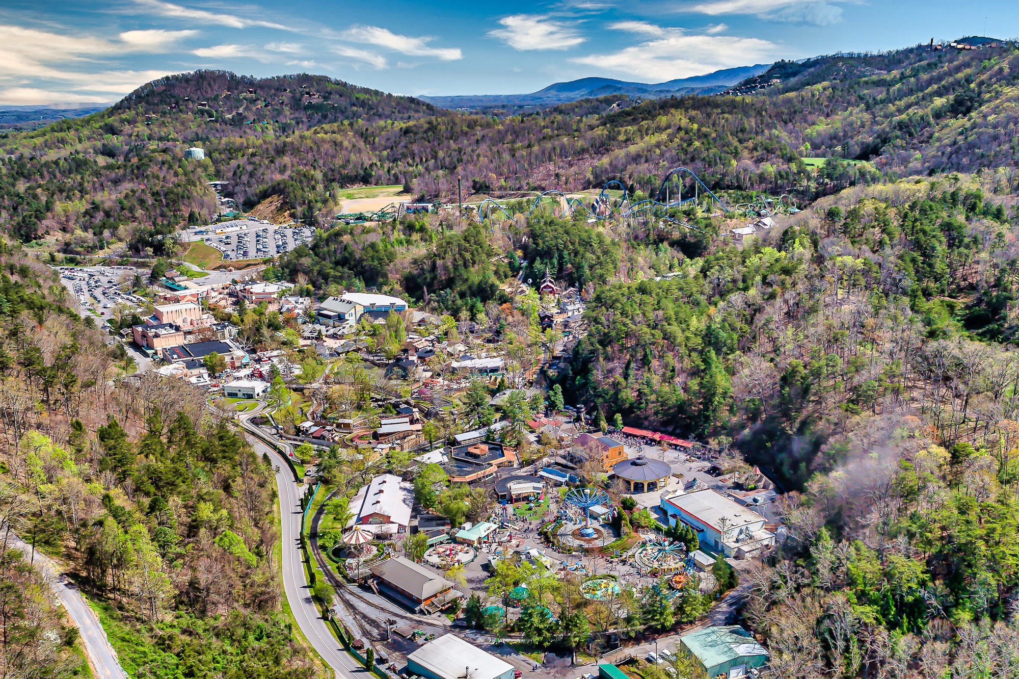 Aerial view of Dollywood theme park with a roller coaster winding through the Smoky Mountains